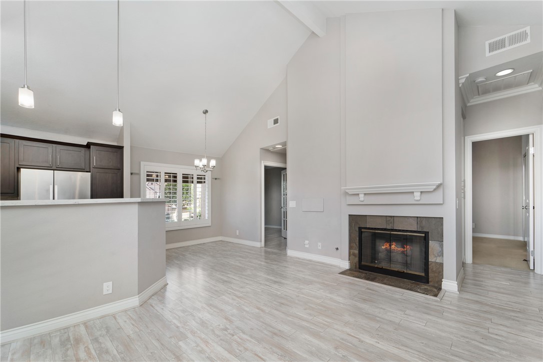 9 Sunbridge Place Dana Point, CA 92629 - Photo 9 of 21 a view of an empty room with wooden floor and a kitchen