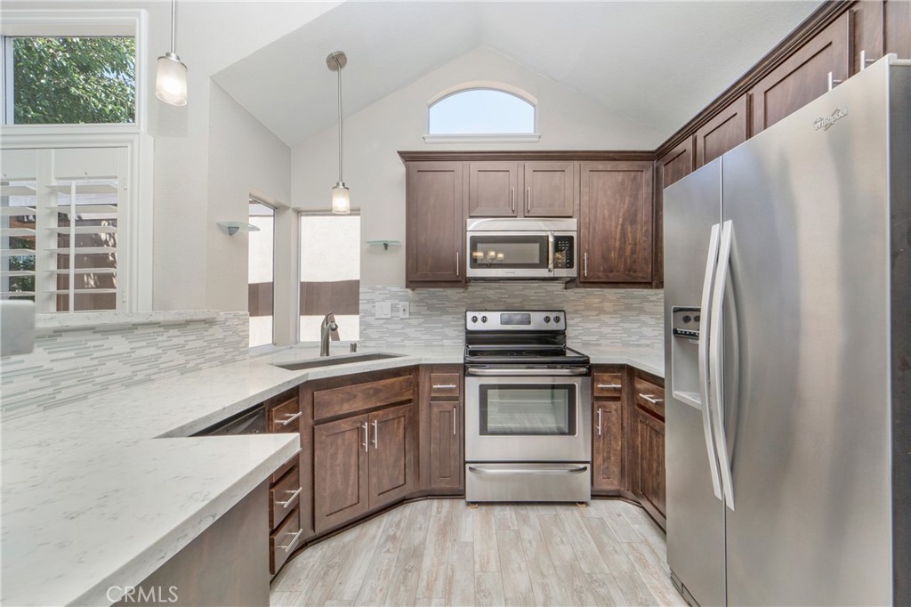 9 Sunbridge Place Dana Point, CA 92629 - Photo 10 of 21 a kitchen with stainless steel appliances a sink cabinets and a refrigerator