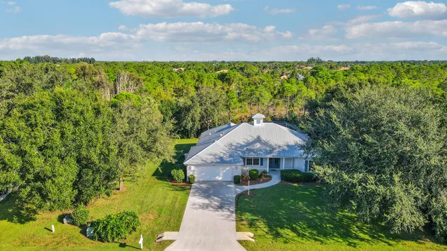 a aerial view of a house with a yard and a fountain