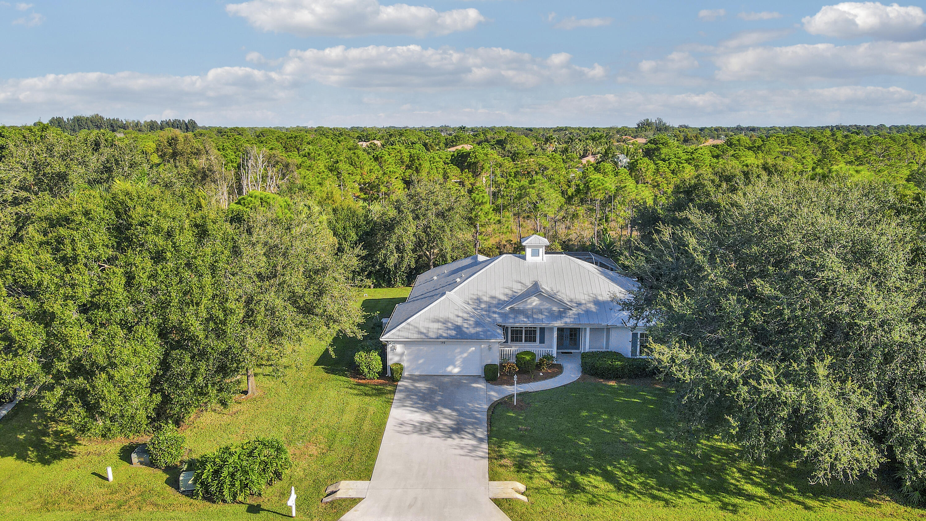 149 Southeast Ashley Oaks Way Stuart, FL 34997 - Photo 1 of 47 a aerial view of a house with a yard and a fountain