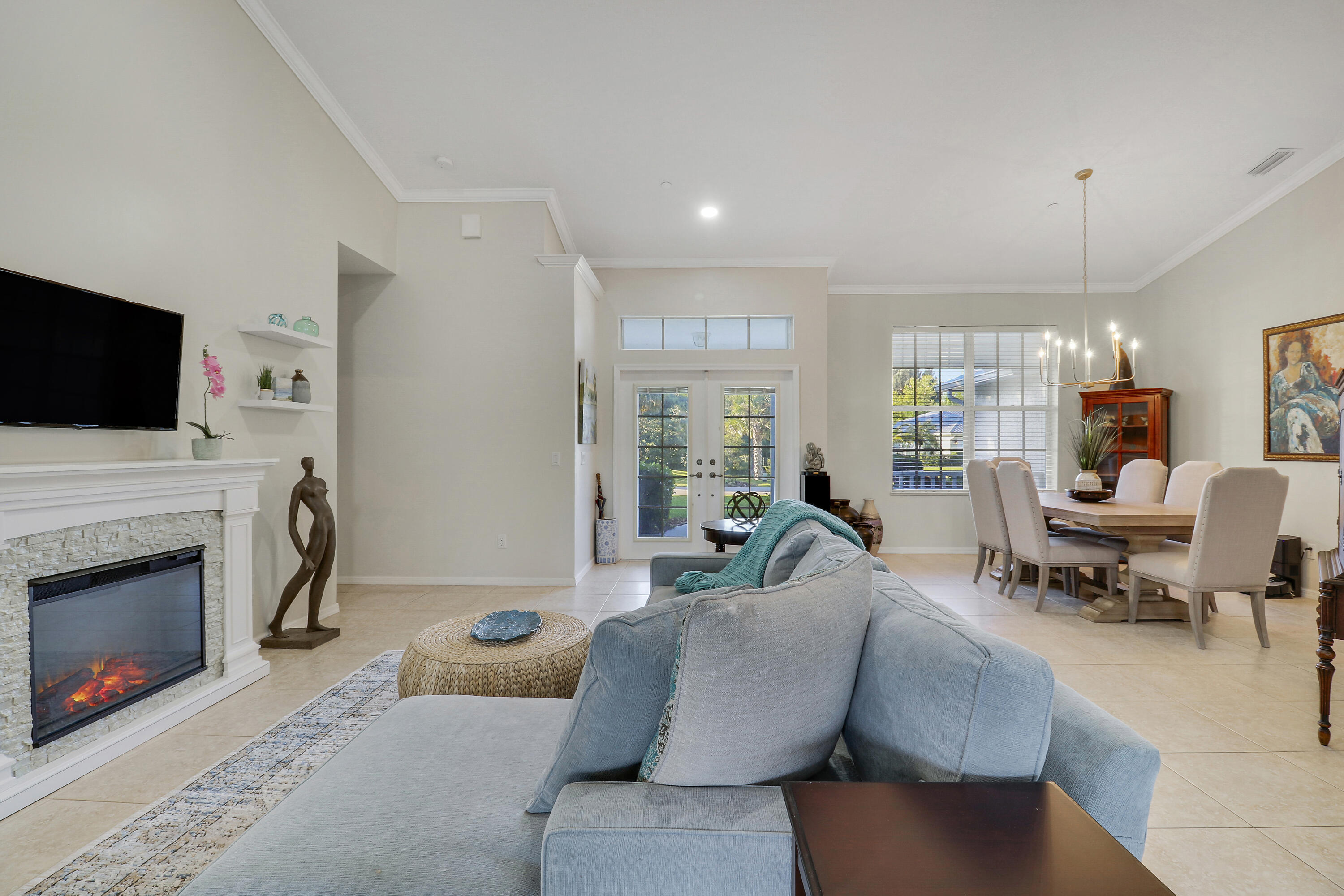 149 Southeast Ashley Oaks Way Stuart, FL 34997 - Photo 13 of 47 a living room with furniture a fireplace and a flat screen tv