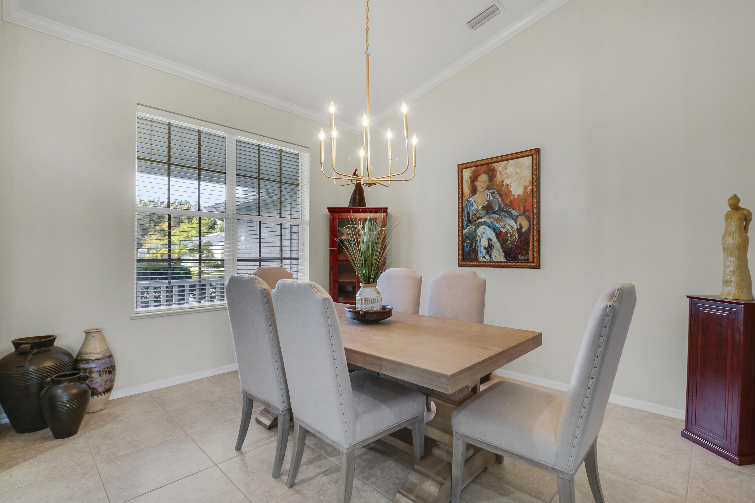 149 Southeast Ashley Oaks Way Stuart, FL 34997 - Photo 14 of 47 a dining room with furniture a chandelier and window