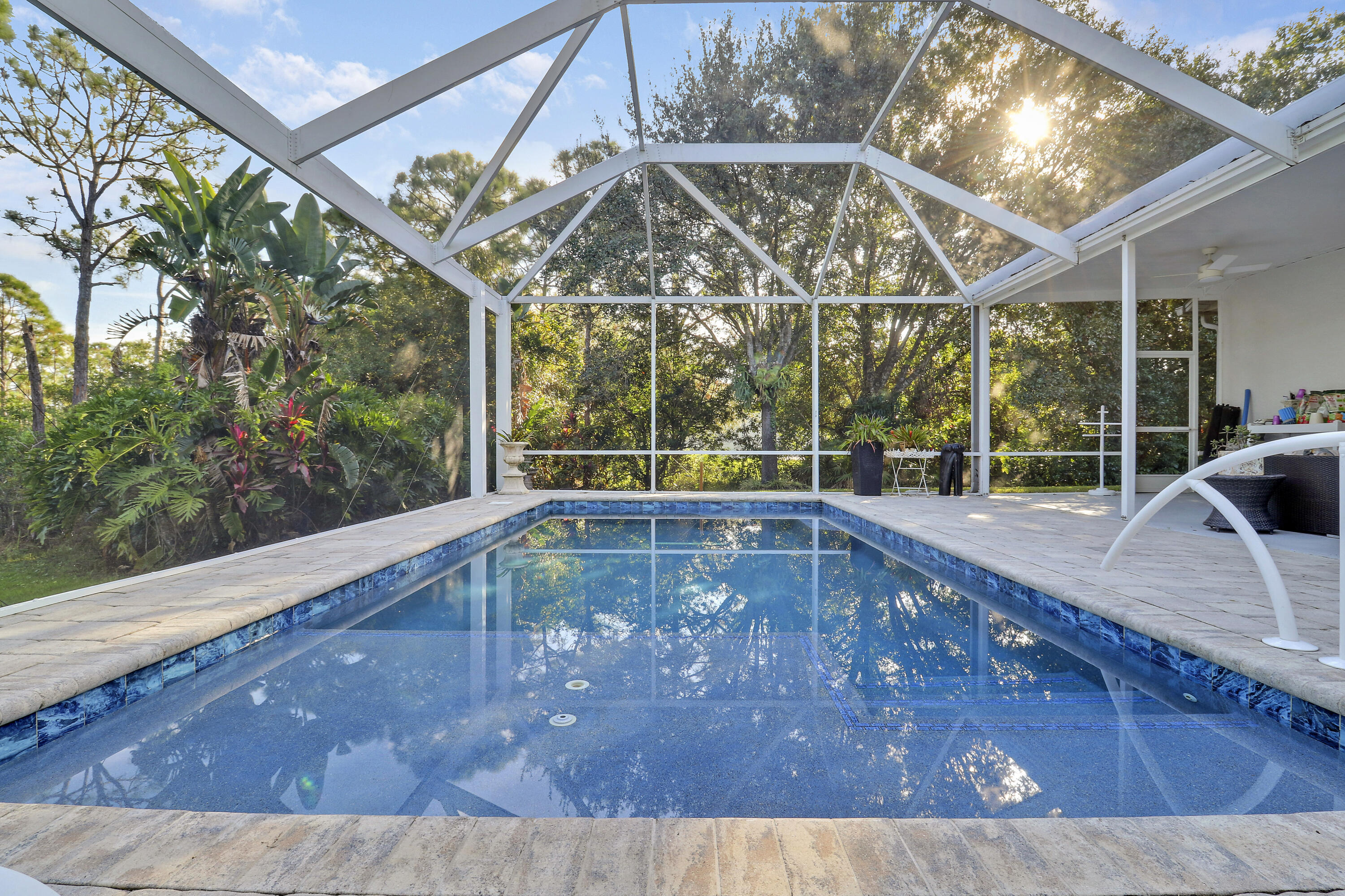 149 Southeast Ashley Oaks Way Stuart, FL 34997 - Photo 2 of 47 a view of a swimming pool with a patio