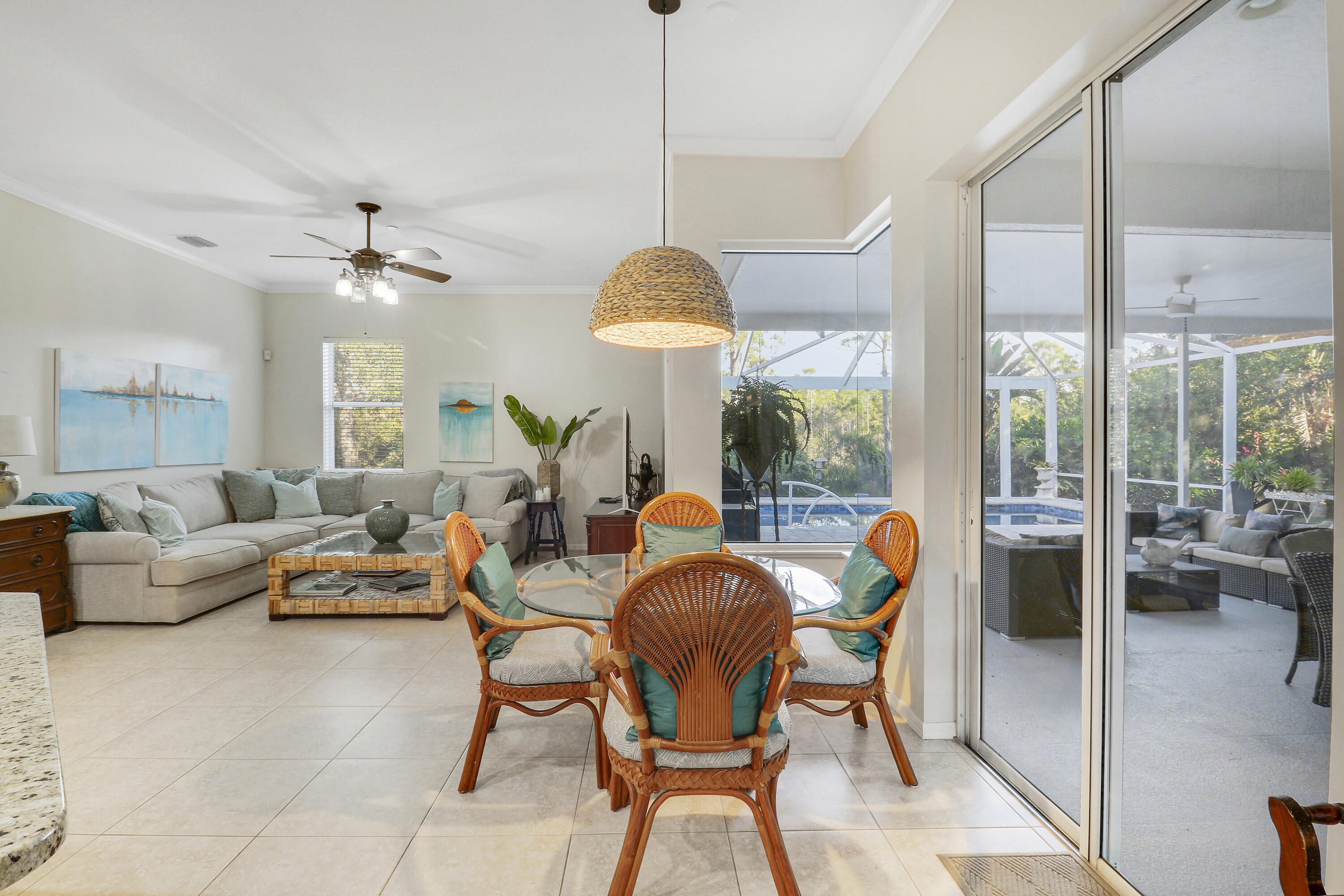 149 Southeast Ashley Oaks Way Stuart, FL 34997 - Photo 24 of 47 a living room with furniture a chandelier and a large window