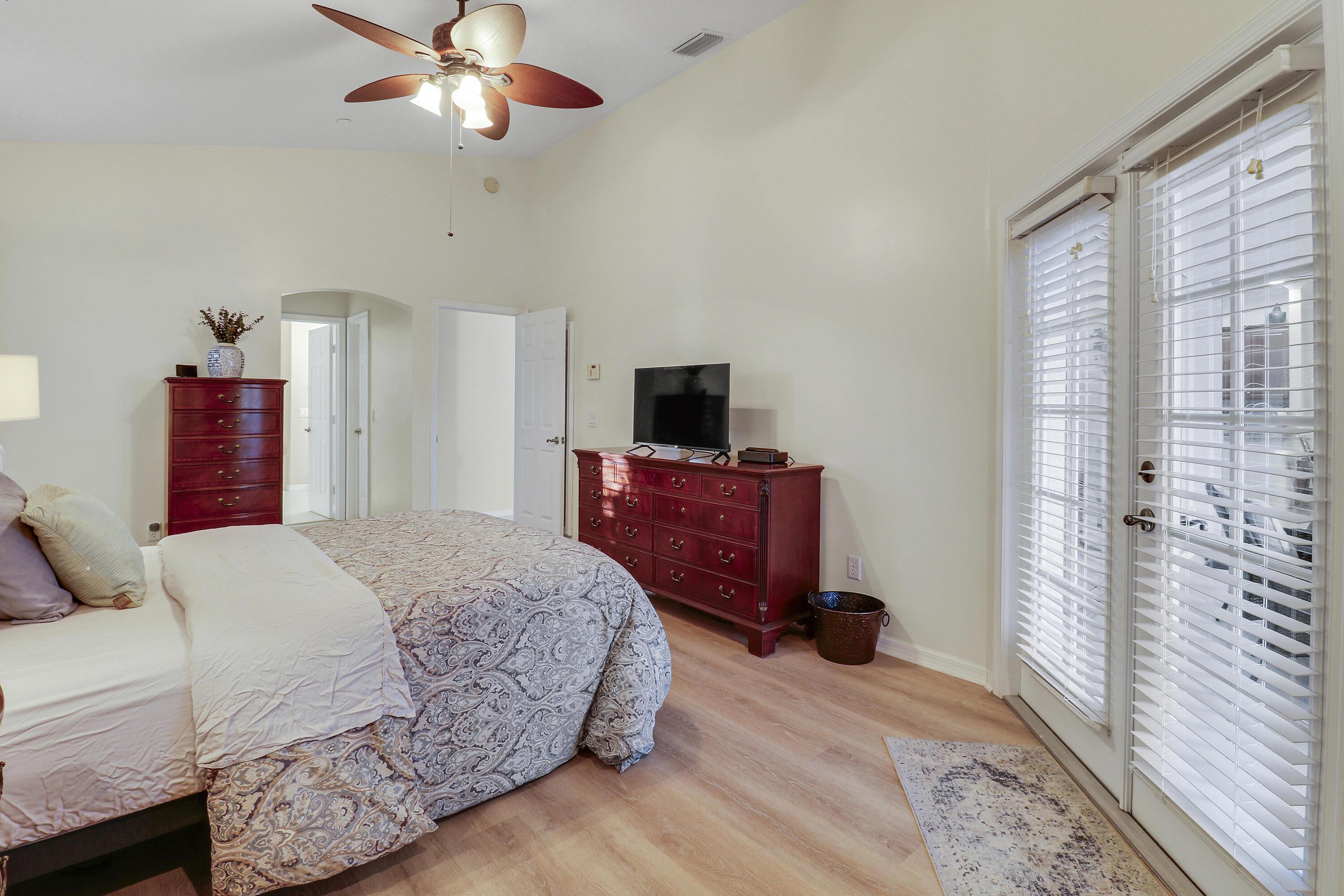 149 Southeast Ashley Oaks Way Stuart, FL 34997 - Photo 26 of 47 a bedroom with a bed and a flat tv screen on dresser