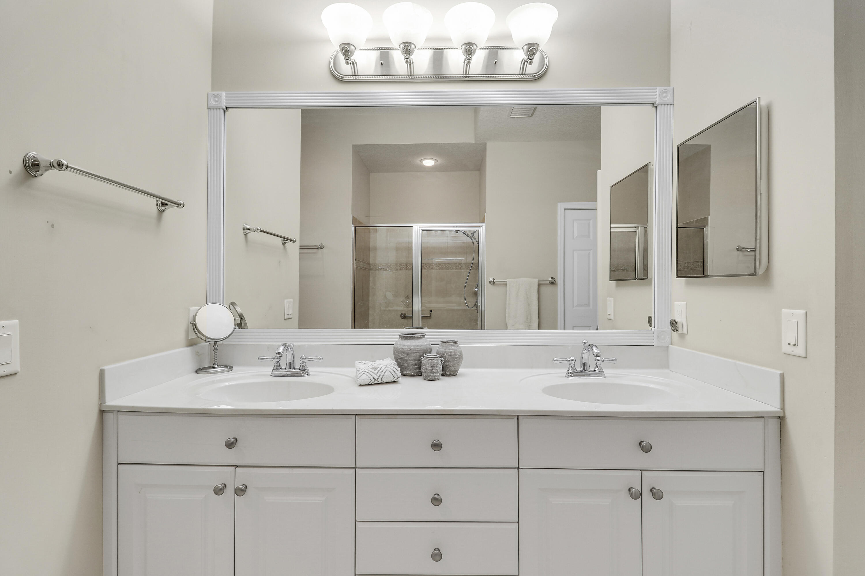 149 Southeast Ashley Oaks Way Stuart, FL 34997 - Photo 28 of 47 a bathroom with double vanity sinks and a mirror
