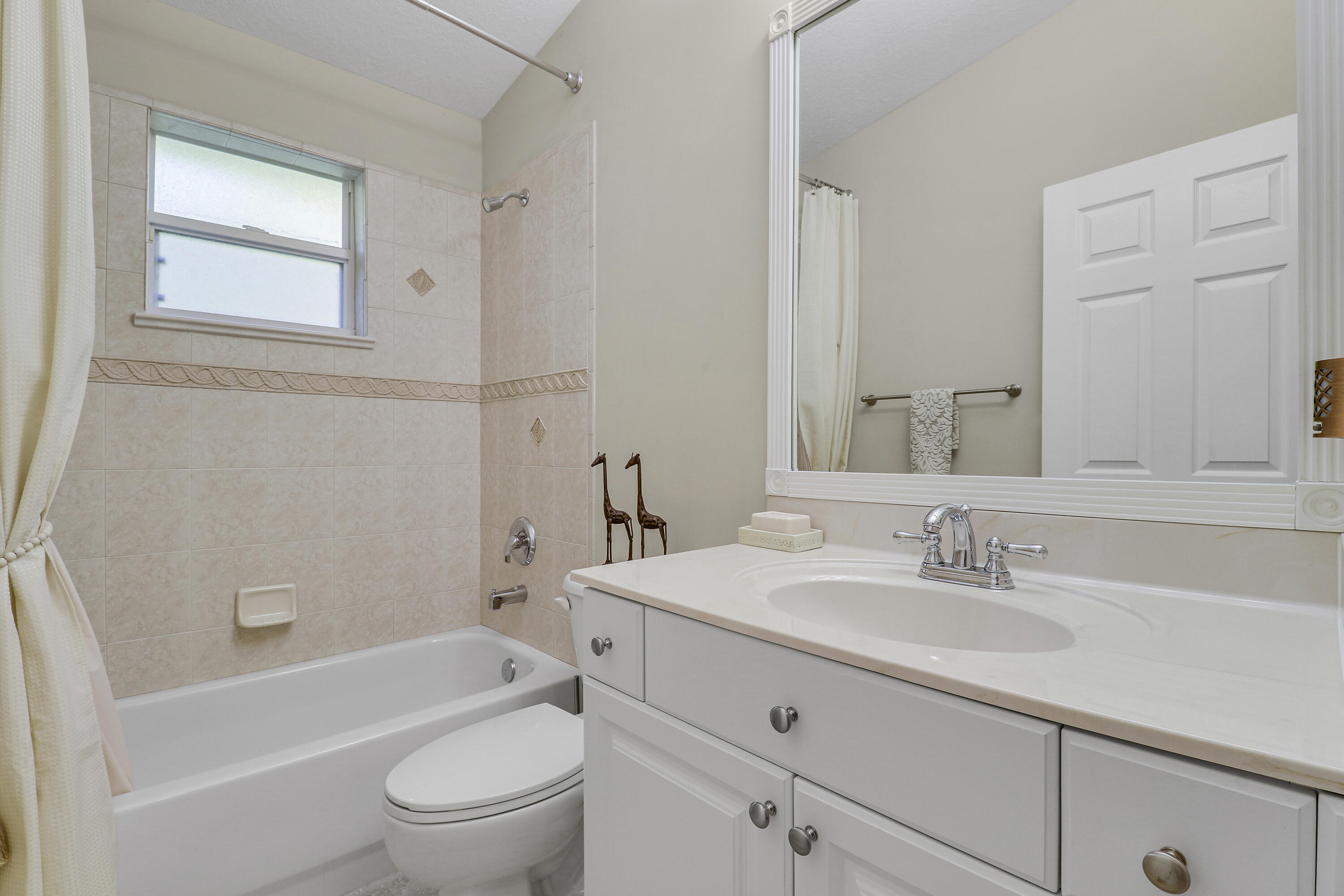 149 Southeast Ashley Oaks Way Stuart, FL 34997 - Photo 32 of 47 a bathroom with a sink toilet a vanity and bathtub