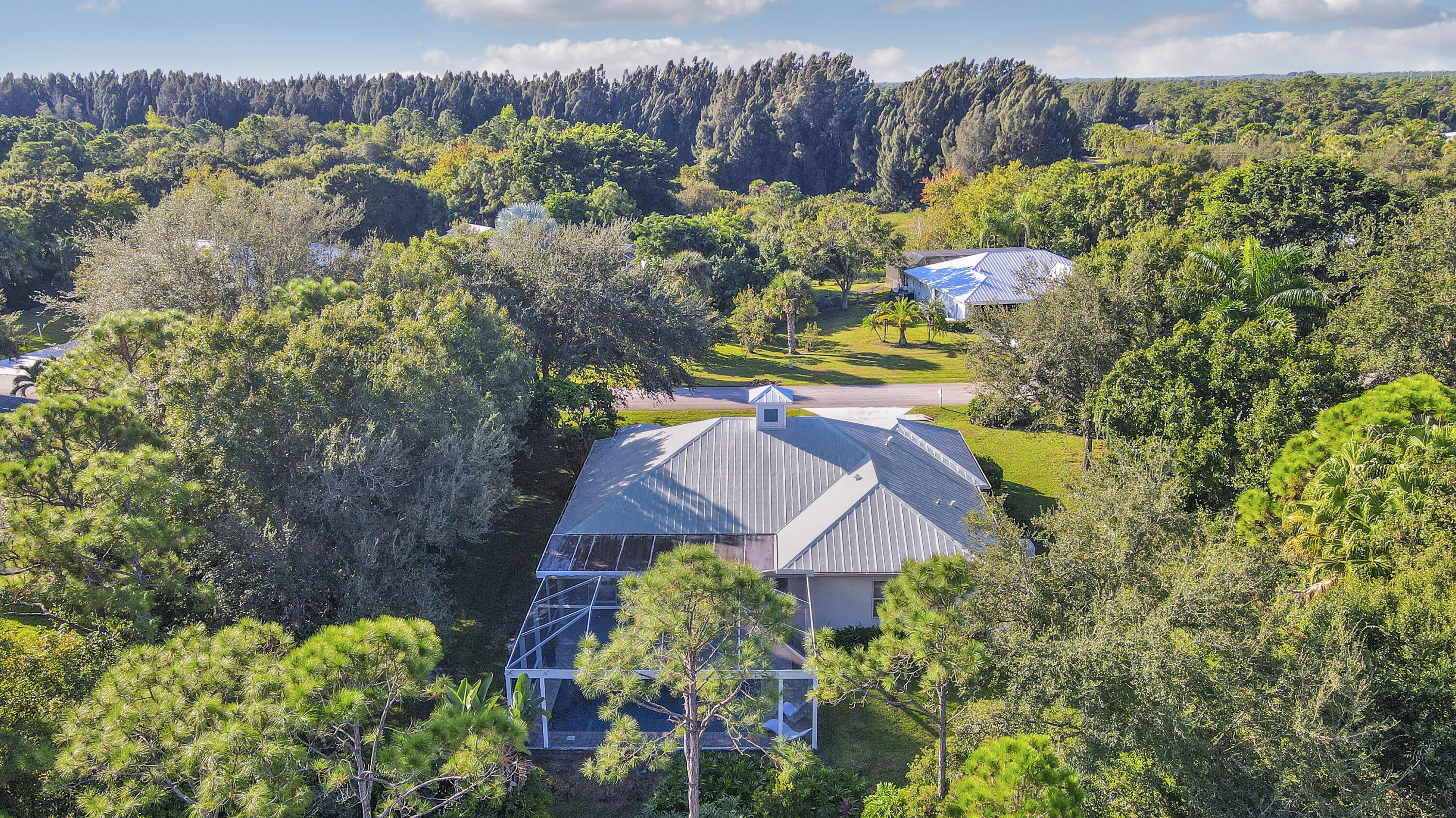 149 Southeast Ashley Oaks Way Stuart, FL 34997 - Photo 7 of 47 view of a house with a yard and a garden