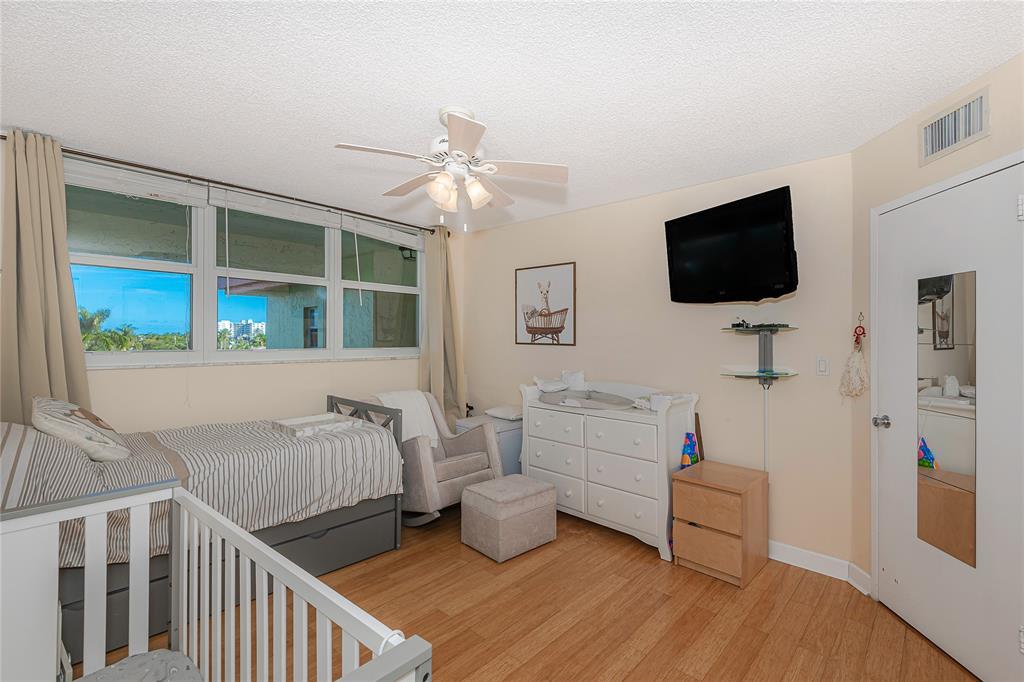 5300 Northeast 24th Terrace, Unit 512 Fort Lauderdale, FL 33308 - Photo 12 of 29 a bedroom with furniture and a flat screen tv