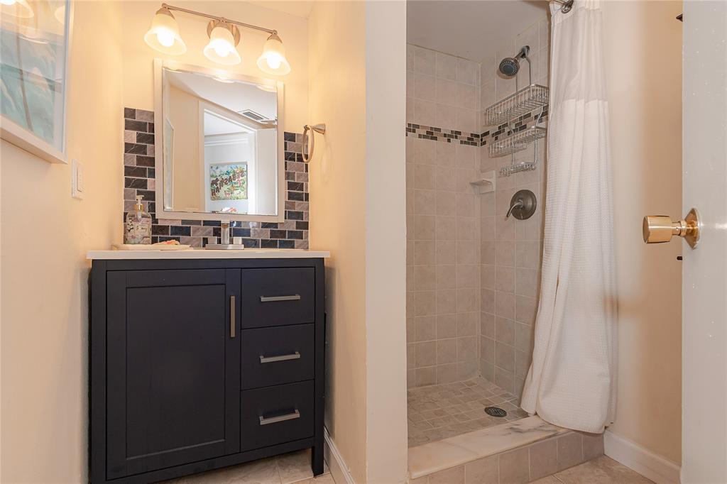 5300 Northeast 24th Terrace, Unit 512 Fort Lauderdale, FL 33308 - Photo 13 of 29 a bathroom with a shower a sink and a mirror