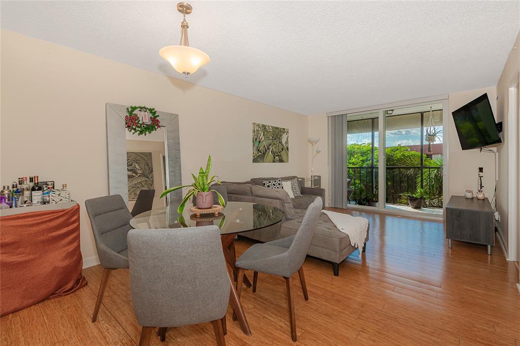 5300 Northeast 24th Terrace, Unit 512 Fort Lauderdale, FL 33308 - Photo 4 of 29 a living room with furniture a flat screen tv and a large window