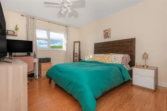 a bedroom with a bed and a flat screen tv