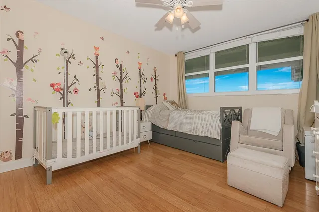 a bedroom with furniture and a flat screen tv