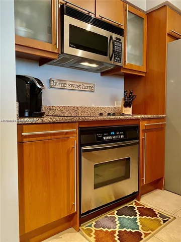 a stove top oven sitting inside of a kitchen