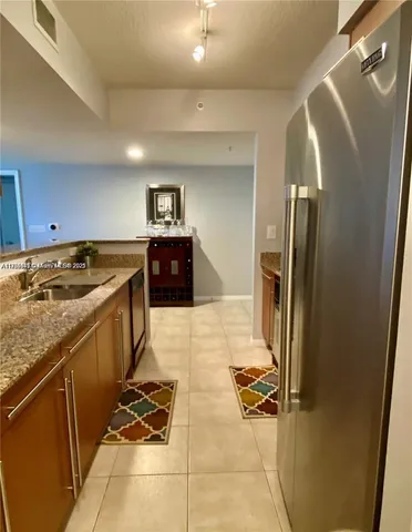 a kitchen with stainless steel appliances granite countertop a refrigerator and a stove