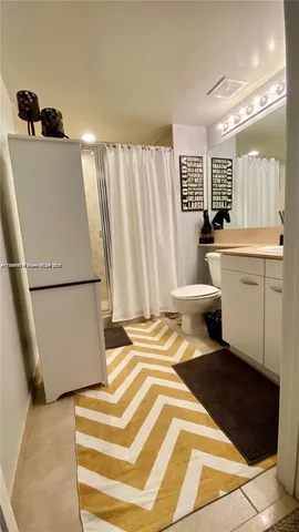 a spacious bathroom with a sink and a mirror