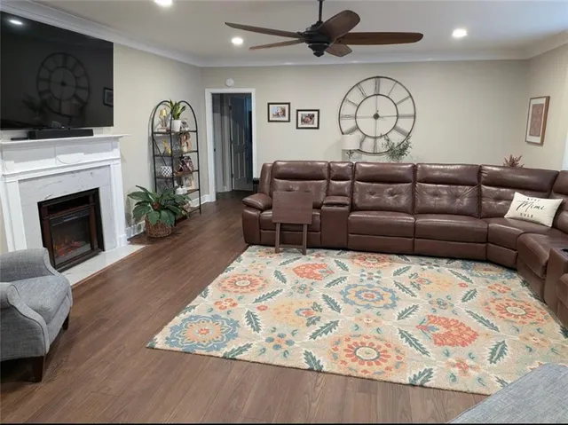 a living room with furniture a flat screen tv and a fireplace