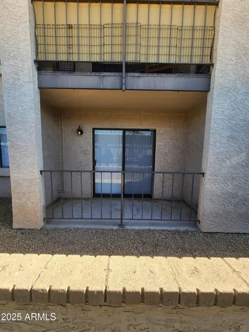 a view of a brick wall with a chair