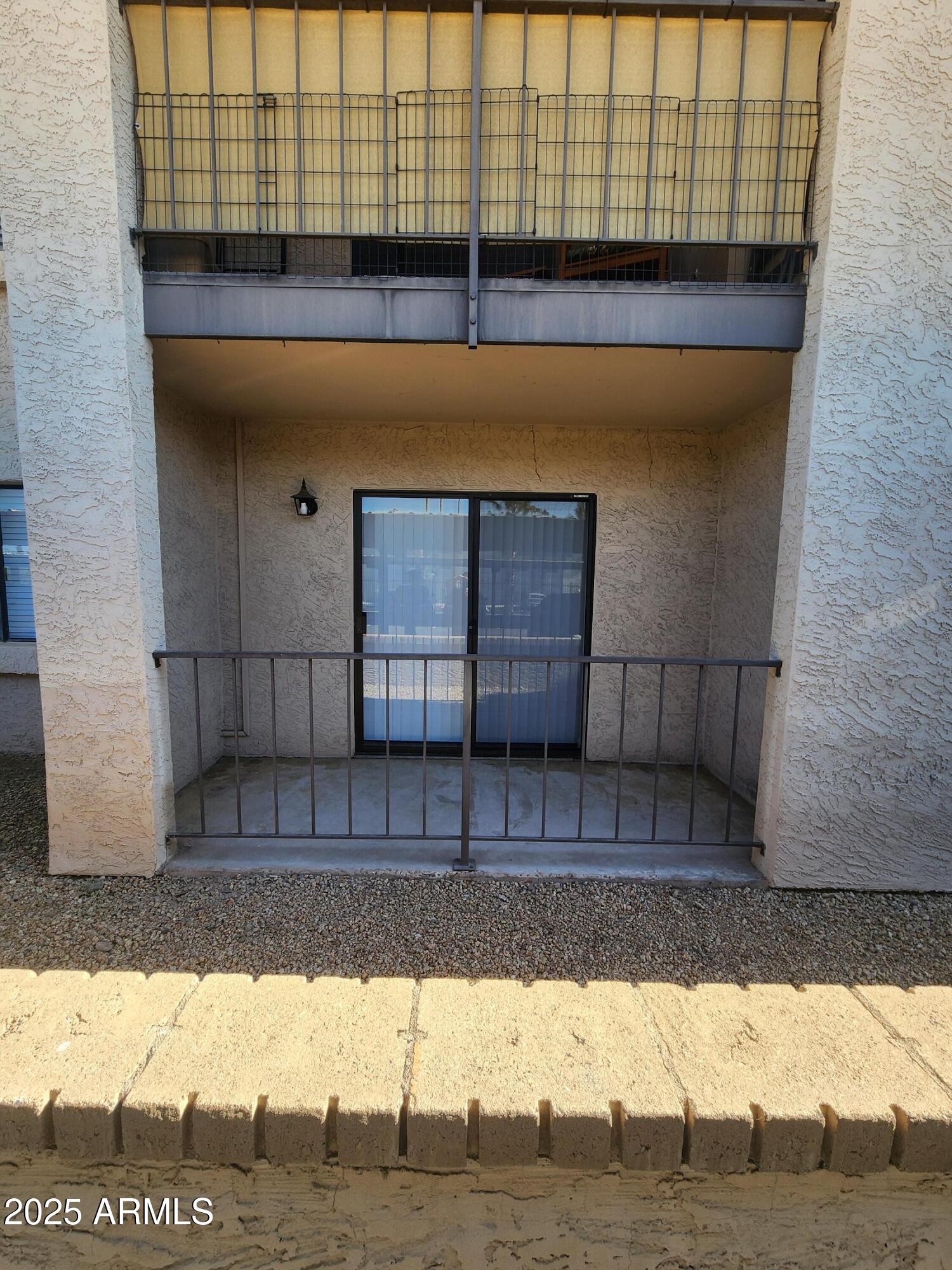 3033 East Devonshire Avenue, Unit 1028 Phoenix, AZ 85016 - Photo 15 of 27 a view of a brick wall with a chair