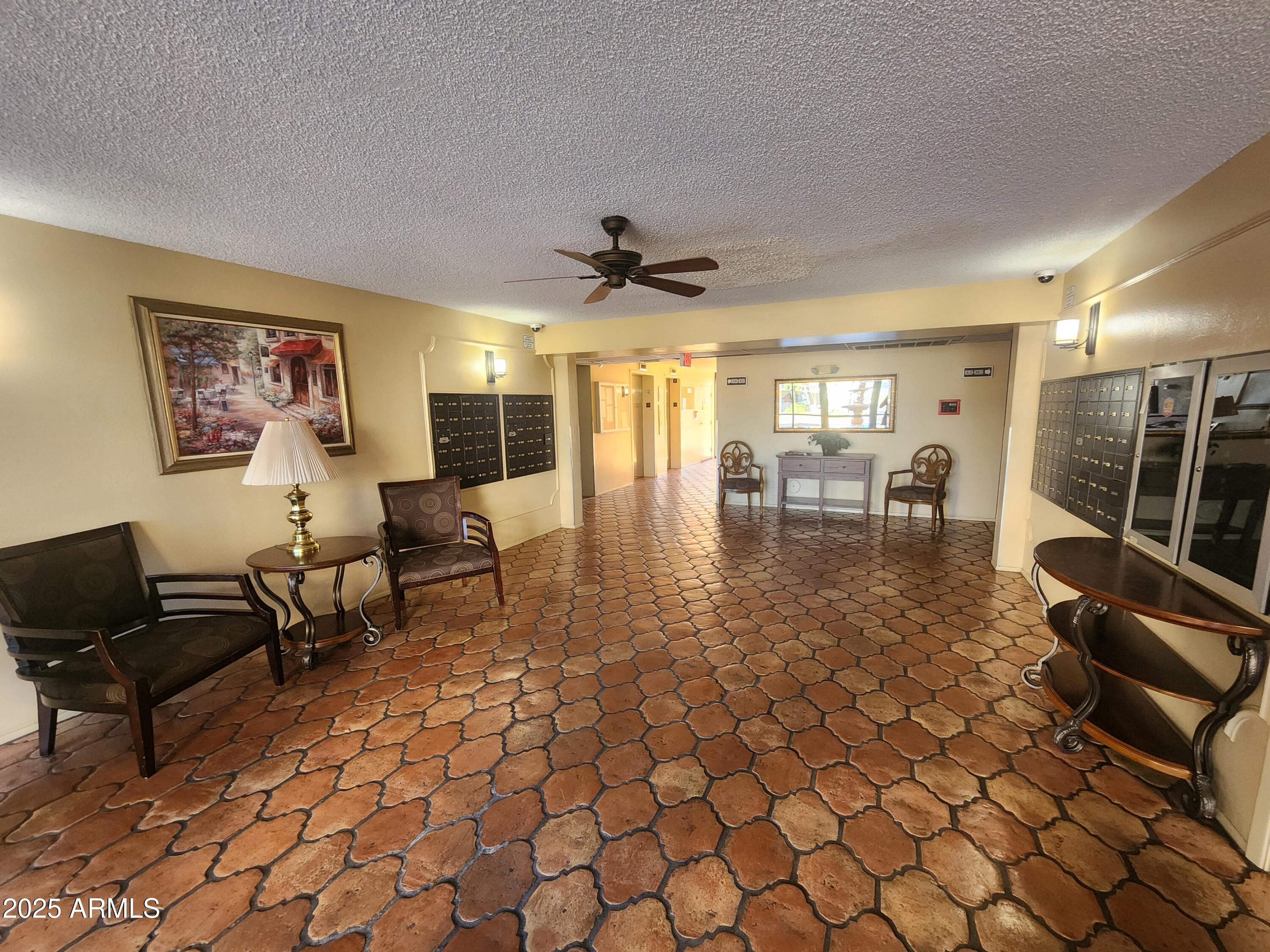 3033 East Devonshire Avenue, Unit 1028 Phoenix, AZ 85016 - Photo 17 of 27 a living room with furniture and a large window