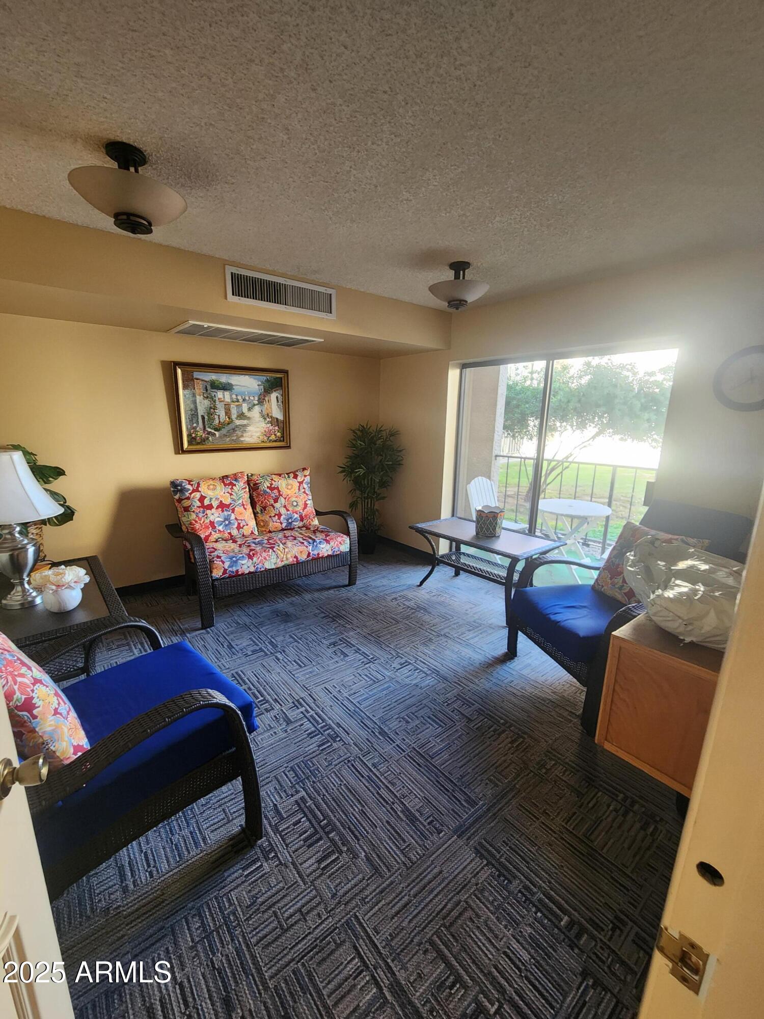 3033 East Devonshire Avenue, Unit 1028 Phoenix, AZ 85016 - Photo 18 of 27 a bedroom with furniture and a large window