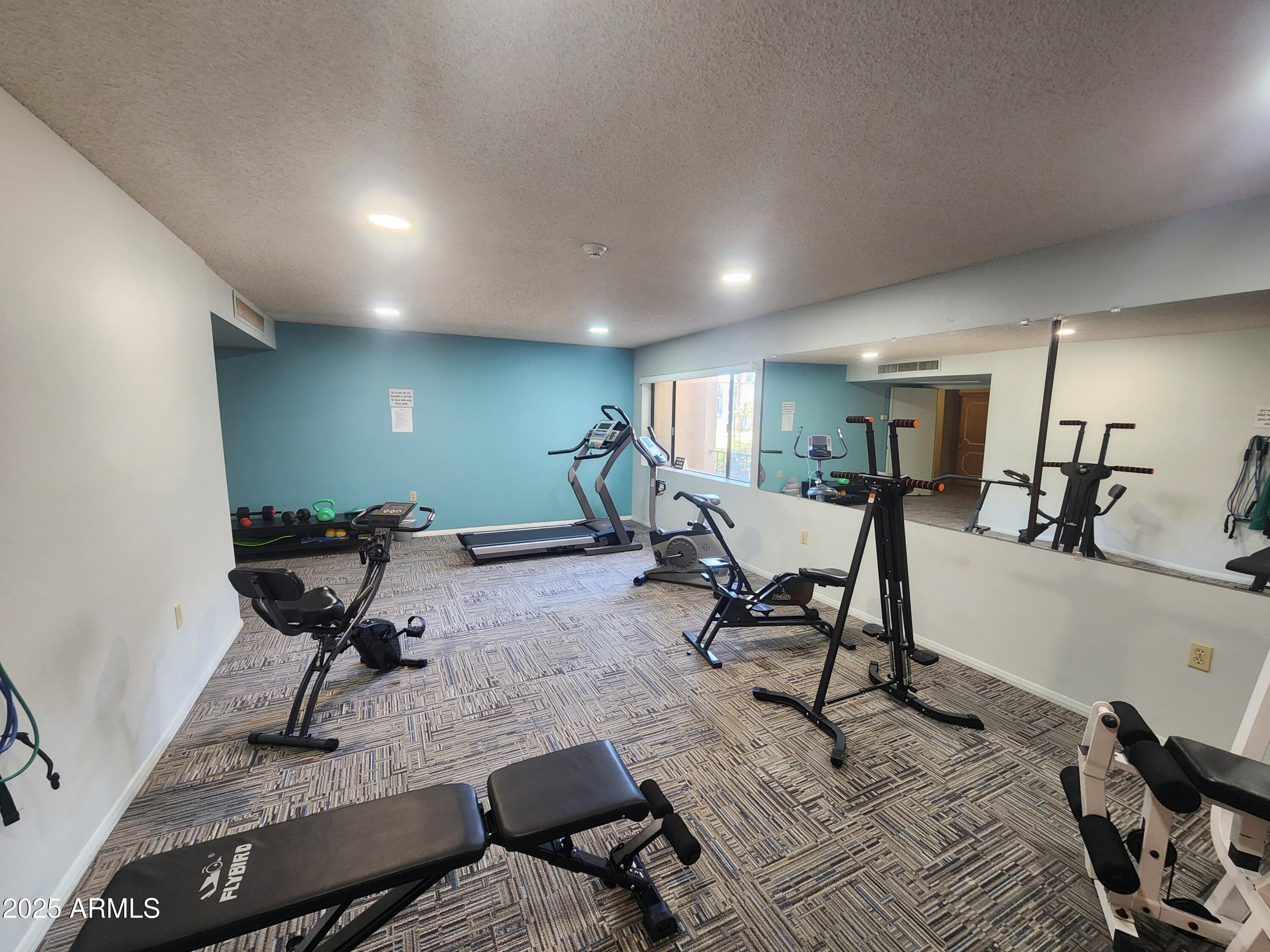 3033 East Devonshire Avenue, Unit 1028 Phoenix, AZ 85016 - Photo 20 of 27 a living room with furniture gym equipment and a view of living room