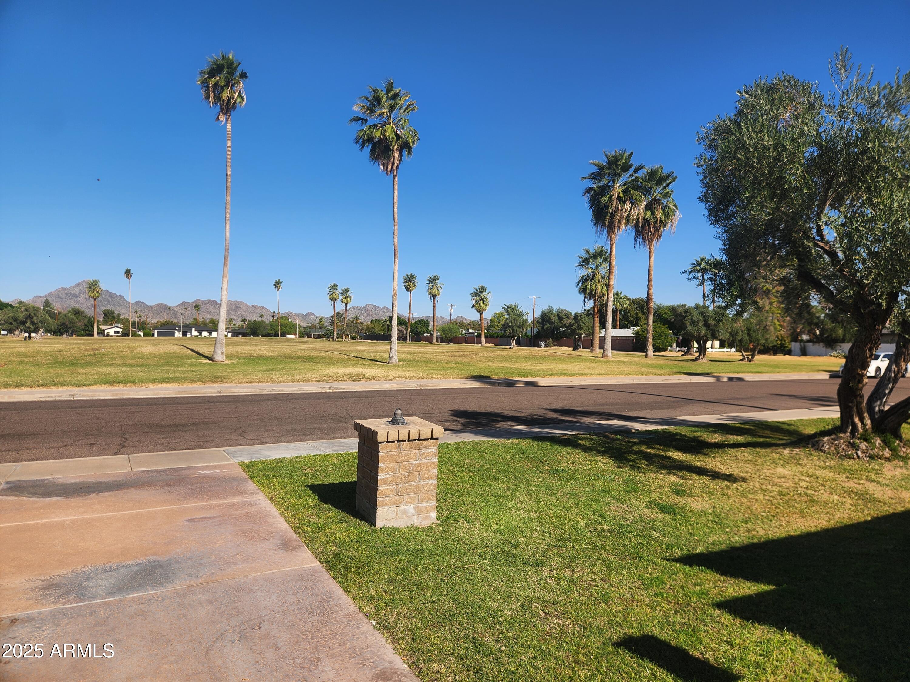 3033 East Devonshire Avenue, Unit 1028 Phoenix, AZ 85016 - Photo 25 of 27 a view of a swimming pool with a yard
