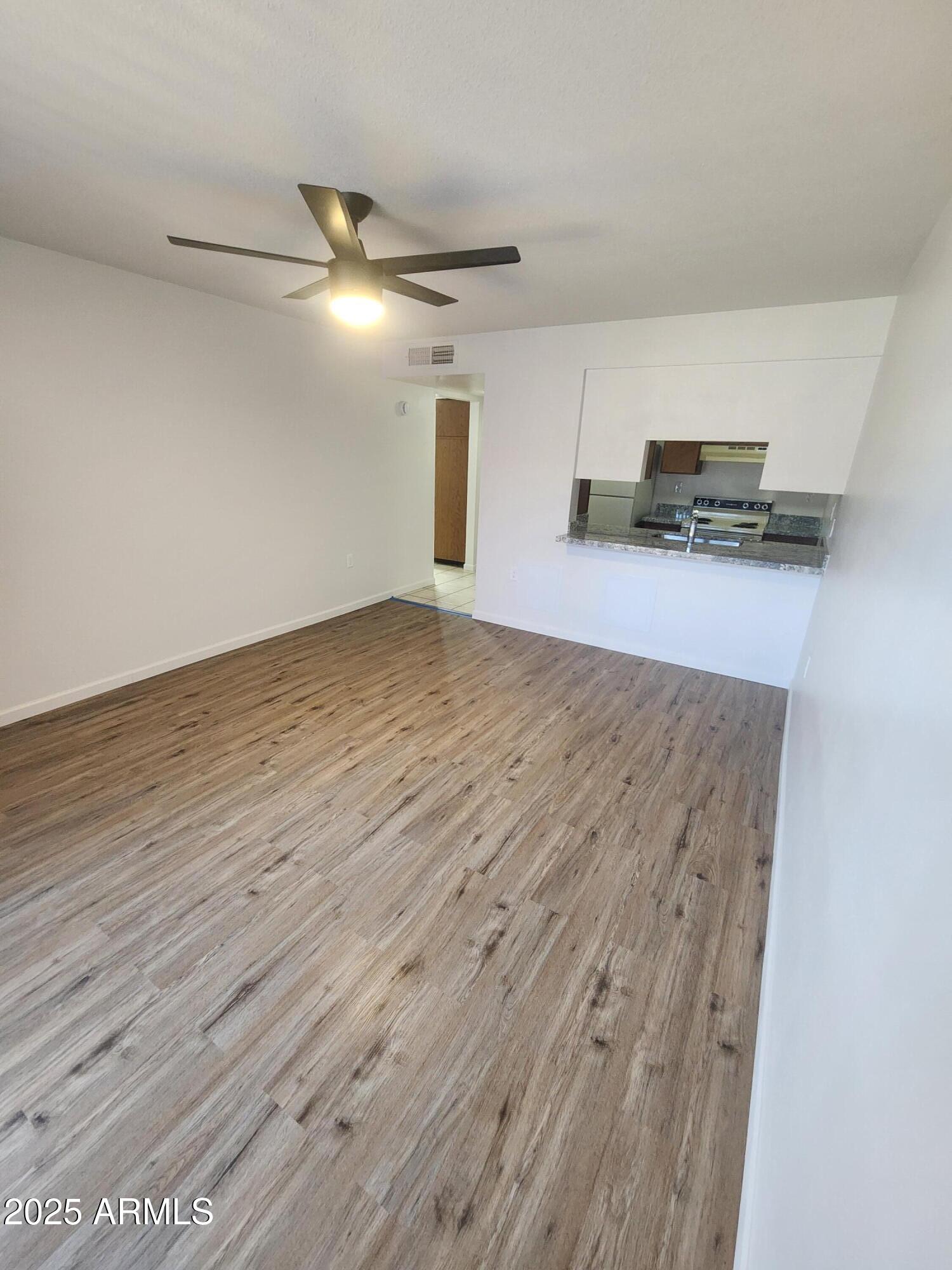3033 East Devonshire Avenue, Unit 1028 Phoenix, AZ 85016 - Photo 6 of 27 a view of empty room with wooden floor