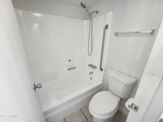 a white toilet next to a bathroom sink
