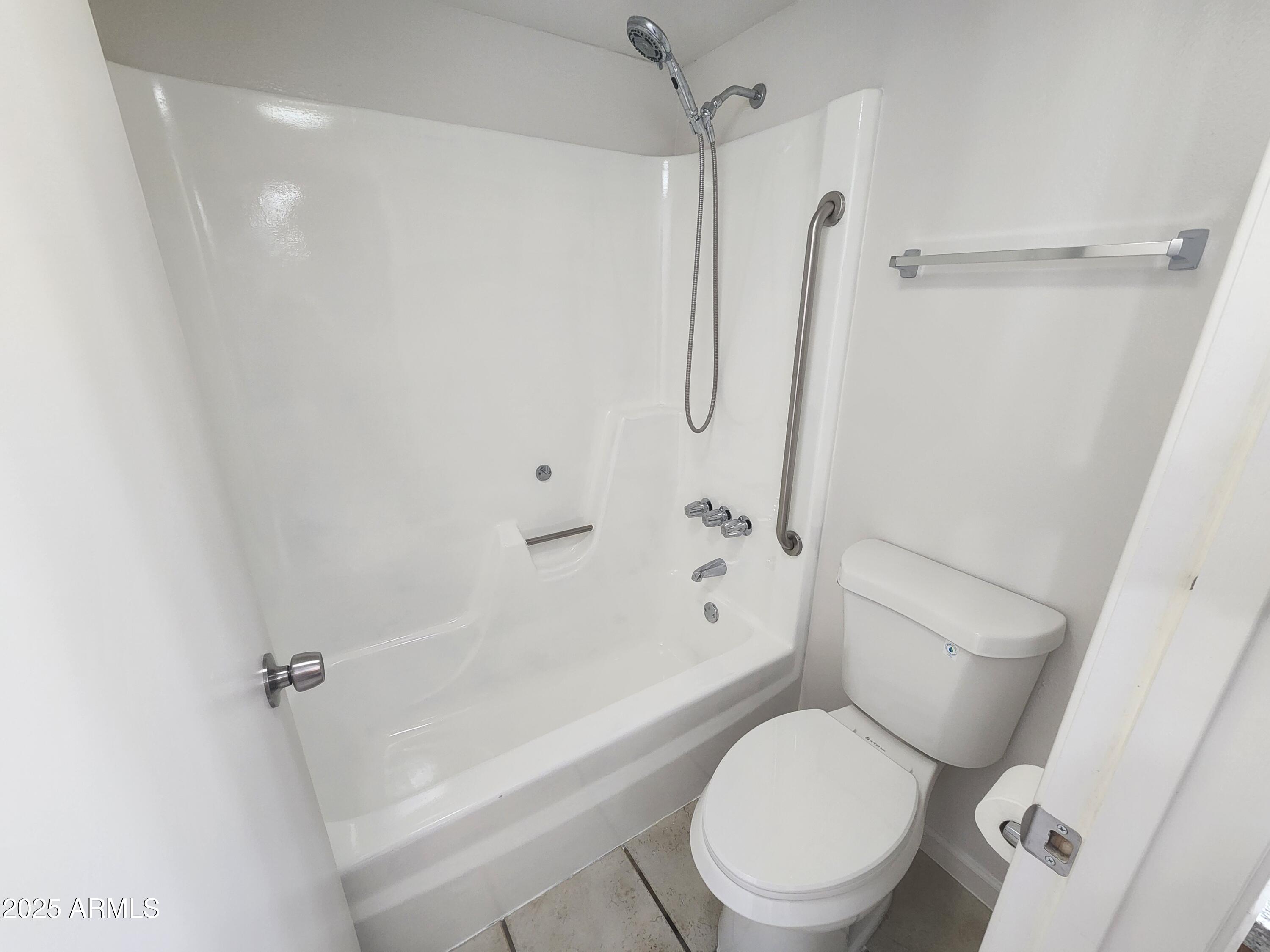 3033 East Devonshire Avenue, Unit 1028 Phoenix, AZ 85016 - Photo 10 of 27 a white toilet next to a bathroom sink