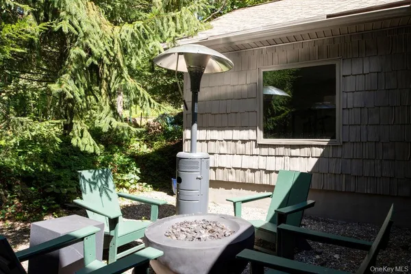 a view of house with a yard and sitting area