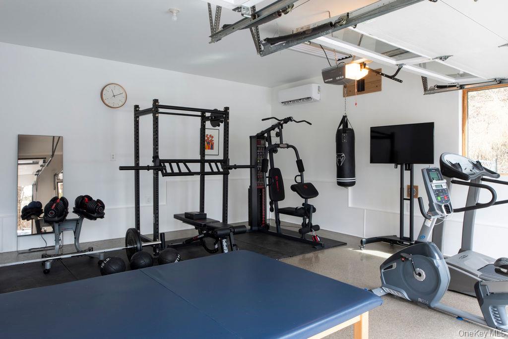 42 Lake Pleasant Road Staatsburg, NY 12580 - Photo 27 of 34 Workout area with a garage and a wall mounted air conditioner (heat/cooling)