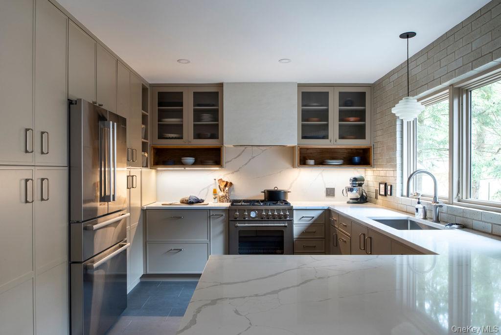 42 Lake Pleasant Road Staatsburg, NY 12580 - Photo 5 of 34 Kitchen with tasteful backsplash, glass insert cabinets, a sink, appliances with stainless steel finishes, and light stone counters