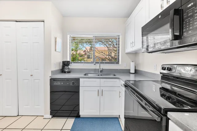 a kitchen with a sink stove and cabinets
