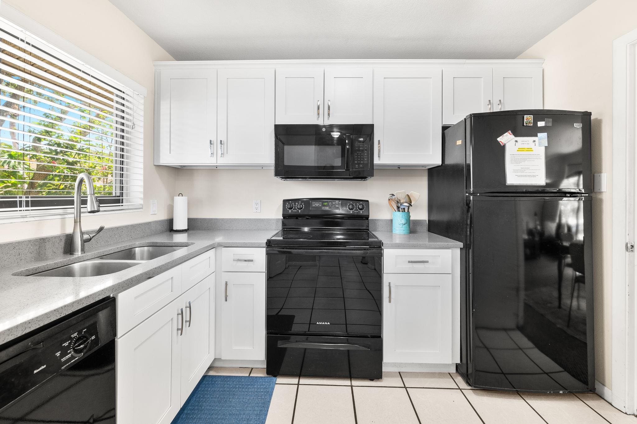 3960 A1A South, Unit 520 St. Augustine, FL 32080 - Photo 12 of 51 a kitchen with a sink a refrigerator and cabinets