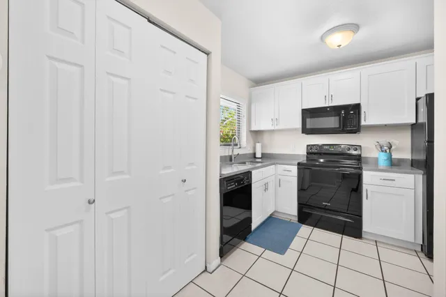 a kitchen with a stove a sink and a microwave