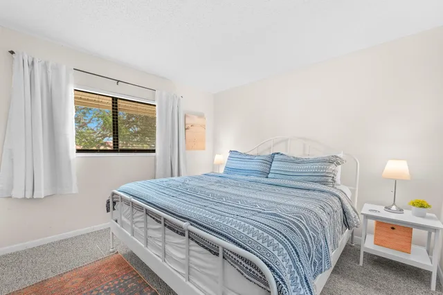 a bedroom with a bed and flat screen tv