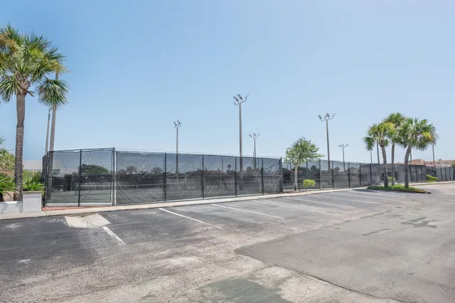 a view of a house with a tree in the yard