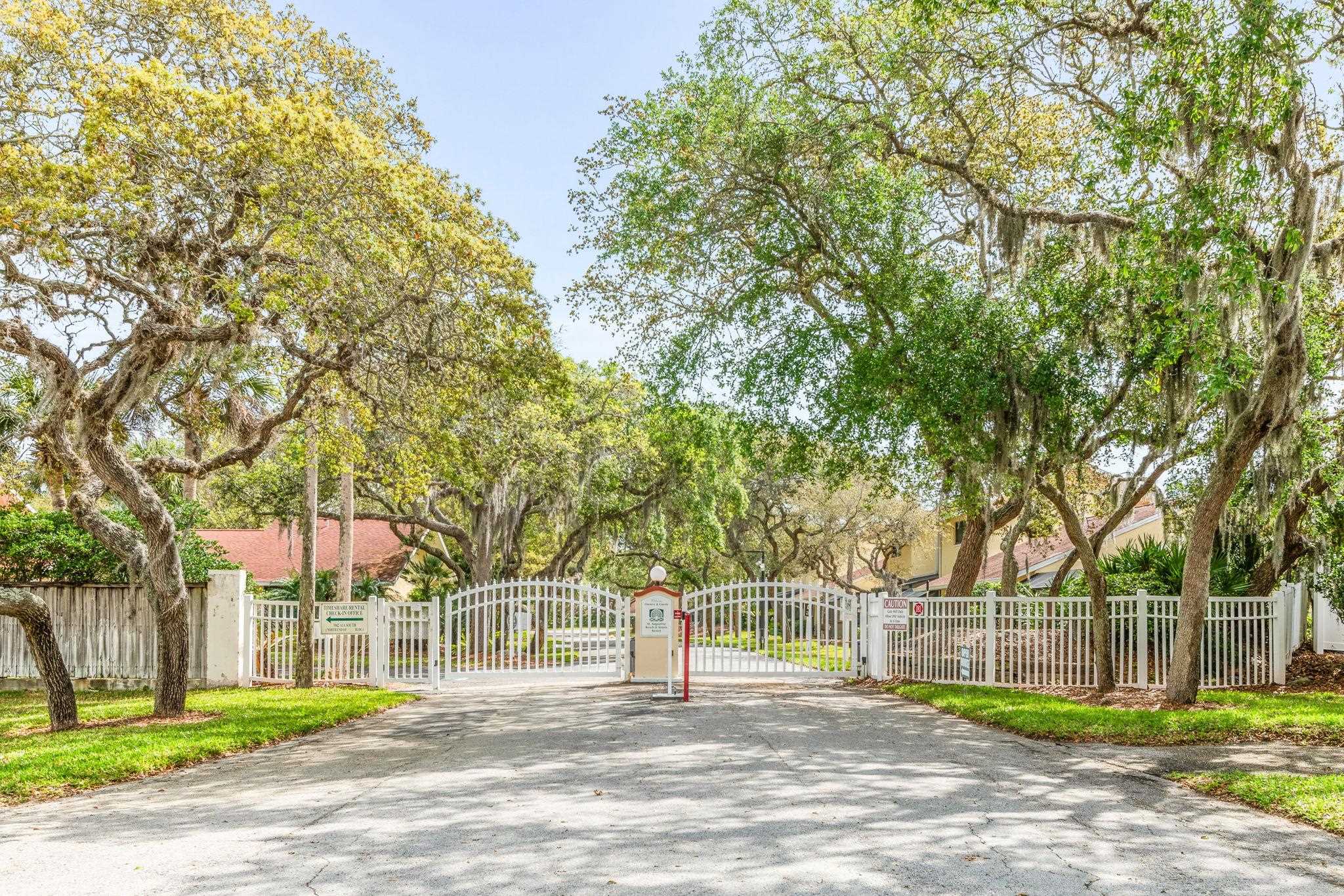 3960 A1A South, Unit 520 St. Augustine, FL 32080 - Photo 34 of 51 a front view of a house with a garden and trees