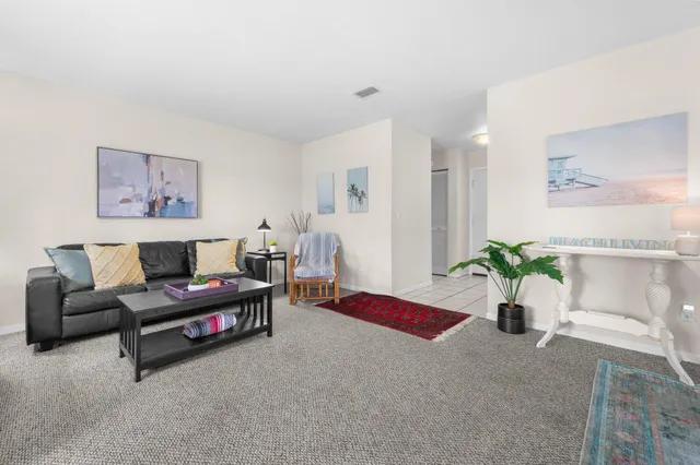 a living room with furniture and flowers