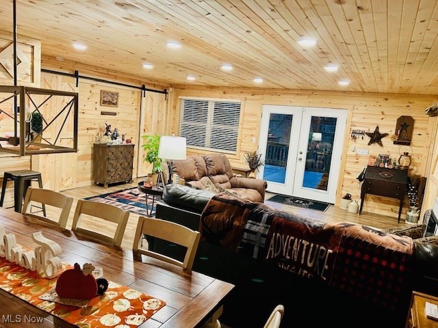 2445 McCord Hill Road Wellsburg, WV 26070 - Photo 13 of 37 Living area with a barn door, wood ceiling, french doors, wood walls, and recessed lighting