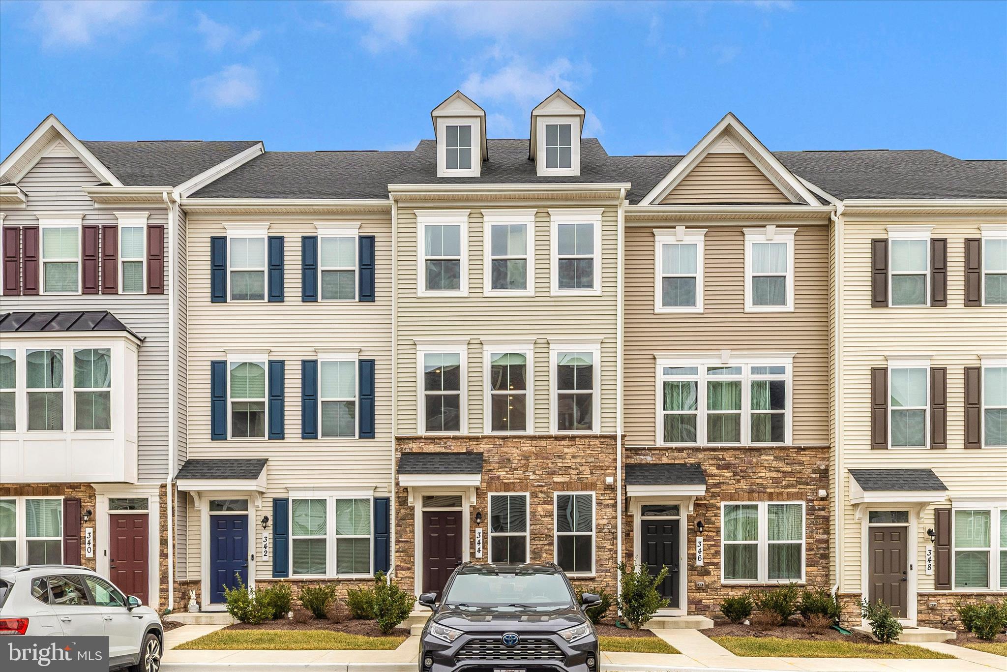 a front view of a residential apartment building with a yard