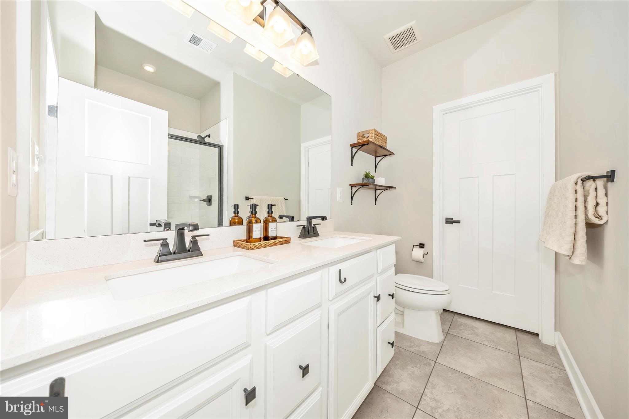 344 Patterson Park Road Frederick, MD 21703 - Photo 15 of 41 a bathroom with a sink a toilet a mirror and shower