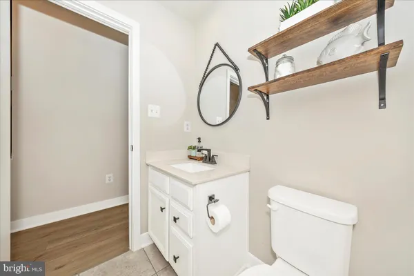 a bathroom with a sink a toilet and a mirror