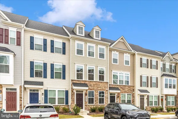 a front view of a residential apartment building with a yard