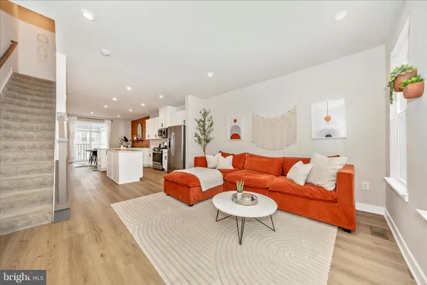 a living room with furniture and kitchen view