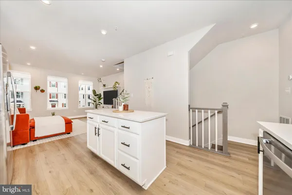 a large white kitchen with stainless steel appliances