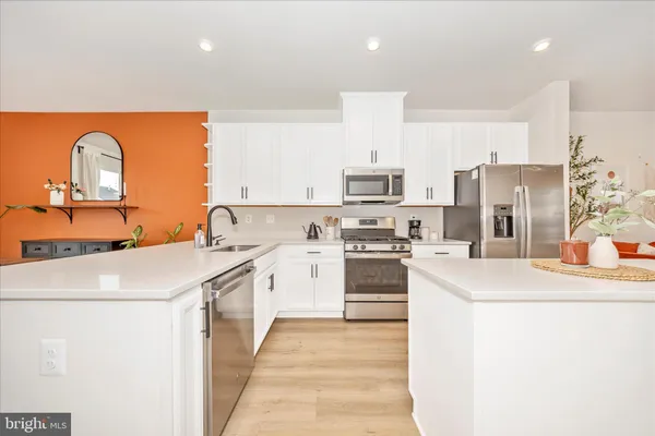 a kitchen with a sink stove and refrigerator