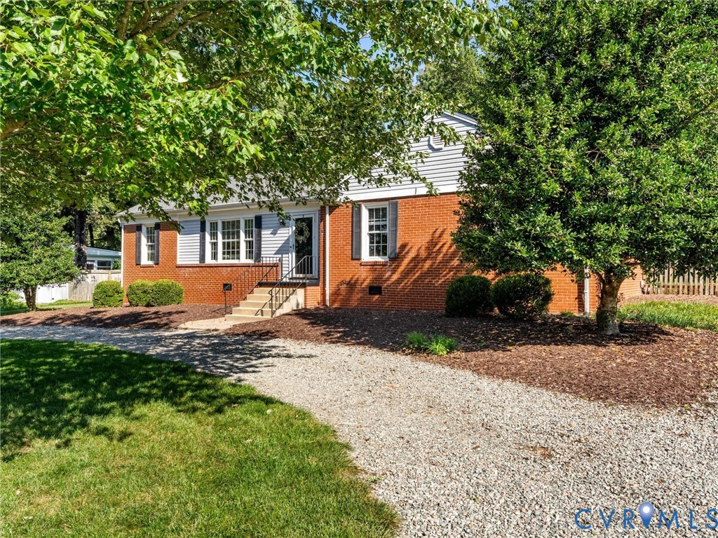 7720 Prairie Road Richmond, VA 23225 - Photo 43 of 49 Brick and siding exterior with a gravel driveway a