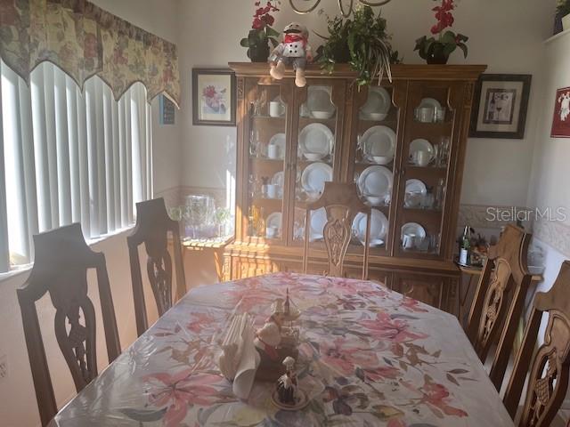 9430 Nakoma Way, Unit 12 Weeki Wachee, FL 34613 - Photo 11 of 20 a bedroom with a bed dresser and a window
